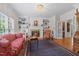 Elegant living room with fireplace, custom built-ins, traditional furnishings, and large windows at 1009 Bentham Dr, Raleigh, NC 27614