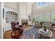Bright living room with a fireplace, built-in bookshelves, and expansive windows at 1009 Bentham Dr, Raleigh, NC 27614
