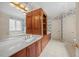 Luxurious main bathroom with double vanity, Jacuzzi tub, and designer wallpaper at 1009 Bentham Dr, Raleigh, NC 27614