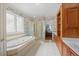 Elegant main bathroom with double vanity, separate shower, and spa tub at 1009 Bentham Dr, Raleigh, NC 27614
