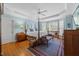 Serene main bedroom with hardwood floors, four-poster bed, and large bay window at 1009 Bentham Dr, Raleigh, NC 27614