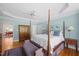 Spacious main bedroom with hardwood floors, four-poster bed, and ensuite access at 1009 Bentham Dr, Raleigh, NC 27614