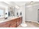 Spacious bathroom with double sinks, custom cabinets, tile floors, and a large mirror at 1054 Contender Dr, Clayton, NC 27520