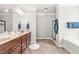 Spacious primary bathroom features a double vanity, walk-in shower, and soaking tub at 1054 Contender Dr, Clayton, NC 27520
