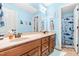 Bright bathroom with a double vanity, wooden cabinets, and beach-themed accents at 1054 Contender Dr, Clayton, NC 27520