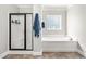 This bathroom features a soaking tub and a walk-in shower with black trim at 1054 Contender Dr, Clayton, NC 27520