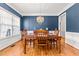 Elegant dining room with wainscoting, chandelier, and large window perfect for entertaining or Gathering meals at 1054 Contender Dr, Clayton, NC 27520