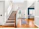 Bright foyer with hardwood floors, stairs, and natural light creating a welcoming entrance to this beautiful home at 1054 Contender Dr, Clayton, NC 27520