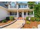 Inviting front porch with walkway, columns and landscaping providing a warm welcome to this beautiful home at 1054 Contender Dr, Clayton, NC 27520