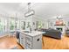Open-concept kitchen featuring a center island, modern lighting, and seamless flow into the living area, ideal for gatherings at 1054 Contender Dr, Clayton, NC 27520