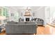 Cozy living room with fireplace, built-in shelving, ceiling fan, and hardwood flooring at 1054 Contender Dr, Clayton, NC 27520