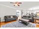 Spacious living room with hardwood floors and comfortable seating with lots of natural light at 1054 Contender Dr, Clayton, NC 27520