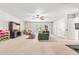 Spacious basement living room with neutral carpet, ceiling fan, and bright natural light at 1054 Contender Dr, Clayton, NC 27520