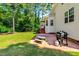 Backyard patio with a BBQ grill, picnic table and adjacent lawn at 1054 Contender Dr, Clayton, NC 27520
