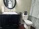 Elegant bathroom featuring a modern black vanity, decorative mirror, and stylish fixtures at 108 Calloway Road Rd, Rocky Mount, NC 27804