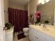 Inviting bathroom featuring a decorative shower curtain, white vanity, and updated lighting at 108 Calloway Road Rd, Rocky Mount, NC 27804