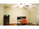 Bright bedroom with ceiling fan, dual monitor desk, and faux fireplace providing a cozy ambiance at 108 Calloway Road Rd, Rocky Mount, NC 27804