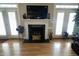 Cozy living room features a fireplace, flanked by French doors, and hardwood floors at 108 Calloway Road Rd, Rocky Mount, NC 27804