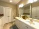 Main bathroom features a dual sink vanity, tile floors, and linen closet for storage at 108 Calloway Road Rd, Rocky Mount, NC 27804