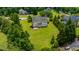 Aerial view of a home with a large backyard including a patio space surrounded by mature trees at 109 Lake Point Dr, Clayton, NC 27527