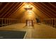 Exposed wooden beams and a plywood floor define the spacious attic, ready for storage or conversion at 109 Lake Point Dr, Clayton, NC 27527