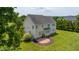 Spacious backyard with a patio, mature trees, and lush green grass at 109 Lake Point Dr, Clayton, NC 27527