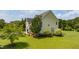 Expansive backyard featuring a lush green lawn and mature trees, perfect for outdoor enjoyment at 109 Lake Point Dr, Clayton, NC 27527