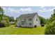 Large, grassy backyard featuring a spacious lawn perfect for outdoor activities at 109 Lake Point Dr, Clayton, NC 27527
