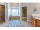 An elegant bathroom with a soaking tub, walk-in shower, double vanity and a decorative rug at 109 Lake Point Dr, Clayton, NC 27527