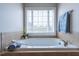 Bright bathroom with a luxurious soaking tub and a window view at 109 Lake Point Dr, Clayton, NC 27527