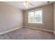 Cozy bedroom featuring neutral walls, plush carpeting, and a bright window at 109 Lake Point Dr, Clayton, NC 27527