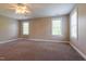 A bright carpeted bedroom features multiple windows offering plenty of natural light at 109 Lake Point Dr, Clayton, NC 27527