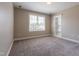 Bedroom with plush carpet, neutral walls, a bright window, and built-in shelving at 109 Lake Point Dr, Clayton, NC 27527