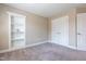 Bedroom with plush carpet, neutral walls, built-in shelving, and a closet at 109 Lake Point Dr, Clayton, NC 27527