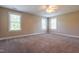 A spacious bedroom features plush carpet, neutral paint, and three large windows at 109 Lake Point Dr, Clayton, NC 27527