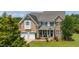 Attractive two-story brick home with a welcoming front porch and a two-car garage at 109 Lake Point Dr, Clayton, NC 27527
