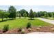 Well-manicured front yard with lush green grass and mature trees at 109 Lake Point Dr, Clayton, NC 27527