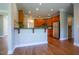 Well-lit kitchen with stainless steel appliances, wooden cabinetry and hardwood floors at 109 Lake Point Dr, Clayton, NC 27527