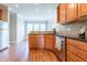 Well-equipped kitchen featuring warm wood cabinets, stainless steel appliances and granite countertops at 109 Lake Point Dr, Clayton, NC 27527