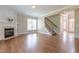 Spacious living room featuring hardwood floors, a fireplace, and staircase at 109 Lake Point Dr, Clayton, NC 27527