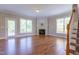 Sunny living room with hardwood floors and fireplace, perfect for relaxation at 109 Lake Point Dr, Clayton, NC 27527