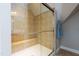 Tiled shower with glass door and built-in bench seating at 109 Lake Point Dr, Clayton, NC 27527