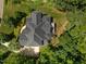 Birds-eye view of the property featuring a large roof, spacious backyard, and lots of surrounding trees at 109 San Juan Dr, Chapel Hill, NC 27514