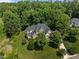 Expansive aerial perspective of a distinguished home with mature trees and a meticulously landscaped lawn at 109 San Juan Dr, Chapel Hill, NC 27514