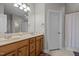 Bathroom with double vanity, wood cabinets, tile floors, and a shower/tub with curtain at 109 San Juan Dr, Chapel Hill, NC 27514