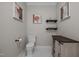 Modern bathroom with a toilet, a cabinet, and artwork on the walls at 109 San Juan Dr, Chapel Hill, NC 27514