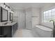 Elegant bathroom with double vanity, soaking tub, and modern fixtures with natural light at 109 San Juan Dr, Chapel Hill, NC 27514
