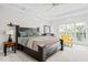 Large bedroom with white carpet, black furniture and a yellow chair near the window at 109 San Juan Dr, Chapel Hill, NC 27514