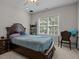 Cozy bedroom features a dark wood bed, ceiling fan, and bright window at 109 San Juan Dr, Chapel Hill, NC 27514
