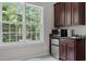 Bright kitchenette area with stainless appliances, granite countertops, and a large window view at 109 San Juan Dr, Chapel Hill, NC 27514